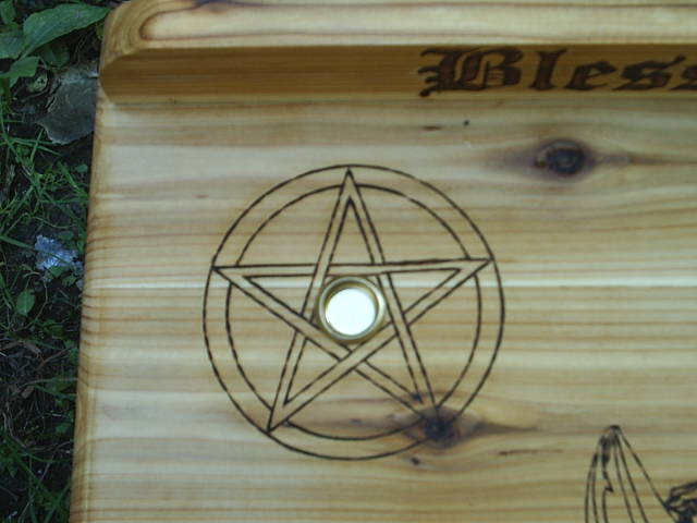 Pentacle with candle holder mounted on the altar