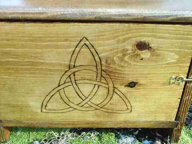 Triquetra on front cabinet door, representing the triple goddess and the three phases of a woman's life, maiden, mother, and crone.